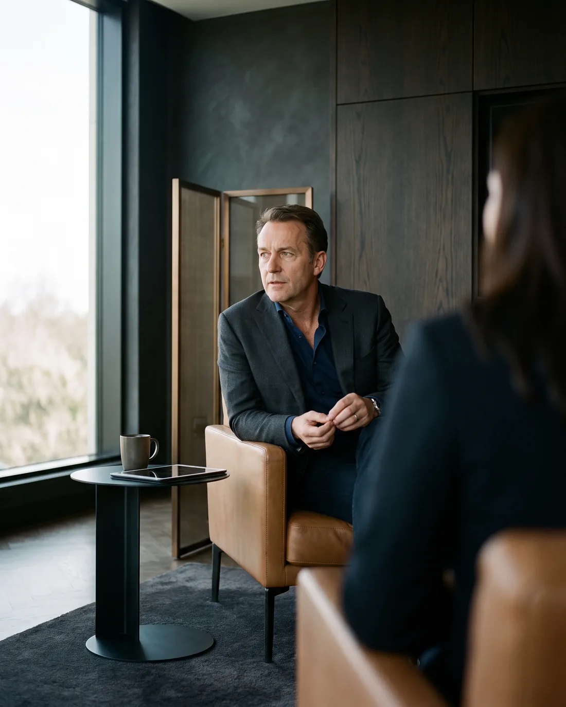 A senior CHRO reviewing the work in a calm London boardroom